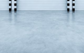 AZ Garage Floors applying high-performance garage epoxy flooring in a commercial warehouse; finish designed for safety and long-term value. Call (602) 254-3363 today for your custom epoxy floor solution.