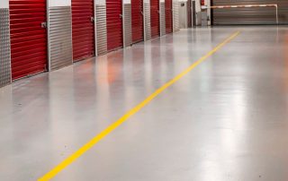 New commercial epoxy coating over an existing floor — AZ Garage Floors technicians restoring durability and shine. Call (602) 254-3363 today to schedule your commercial epoxy floor assessment and upgrade your workspace.