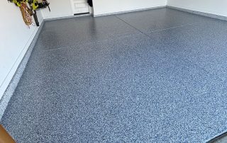 Granitex epoxy floor coating installed by AZ Garage Floors, showing a water-resistant, full-flake surface designed to protect concrete from moisture—call (602) 254-3363 to schedule a free consultation today.